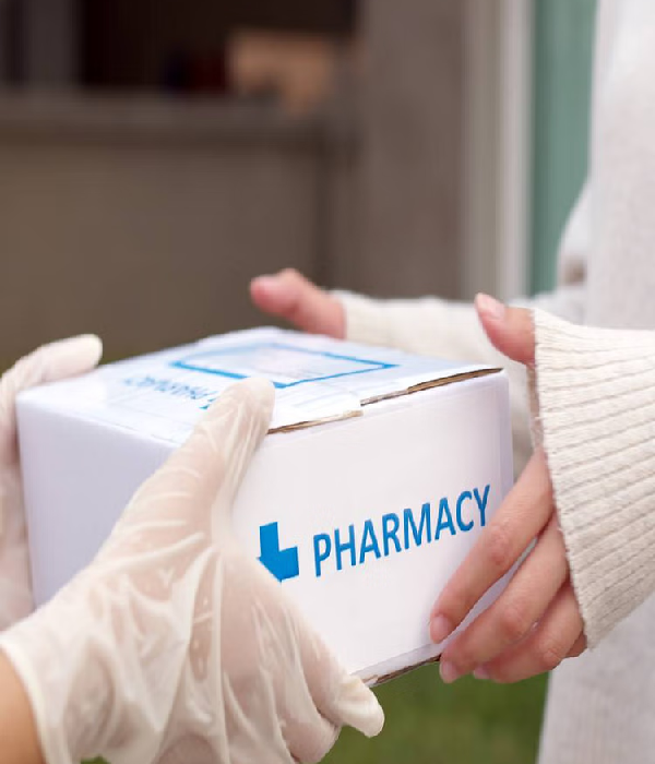 Person receiving a pharmacy delivery package, emphasizing safety and convenience in medical transportation services.