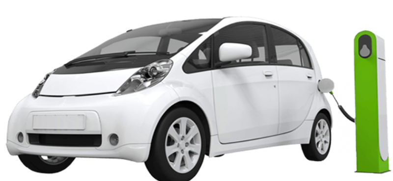 White electric car charging at a green charging station, representing TapTap Eco rideshare service for efficient and sustainable travel.